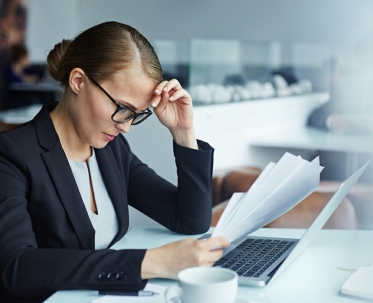 Focused Businesswoman Perusing Contracts